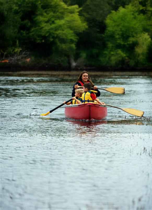 Camp counsellor and campers in kayak